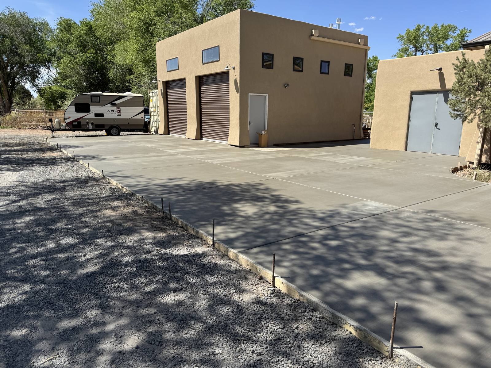 New driveway leading to a stucco shop building